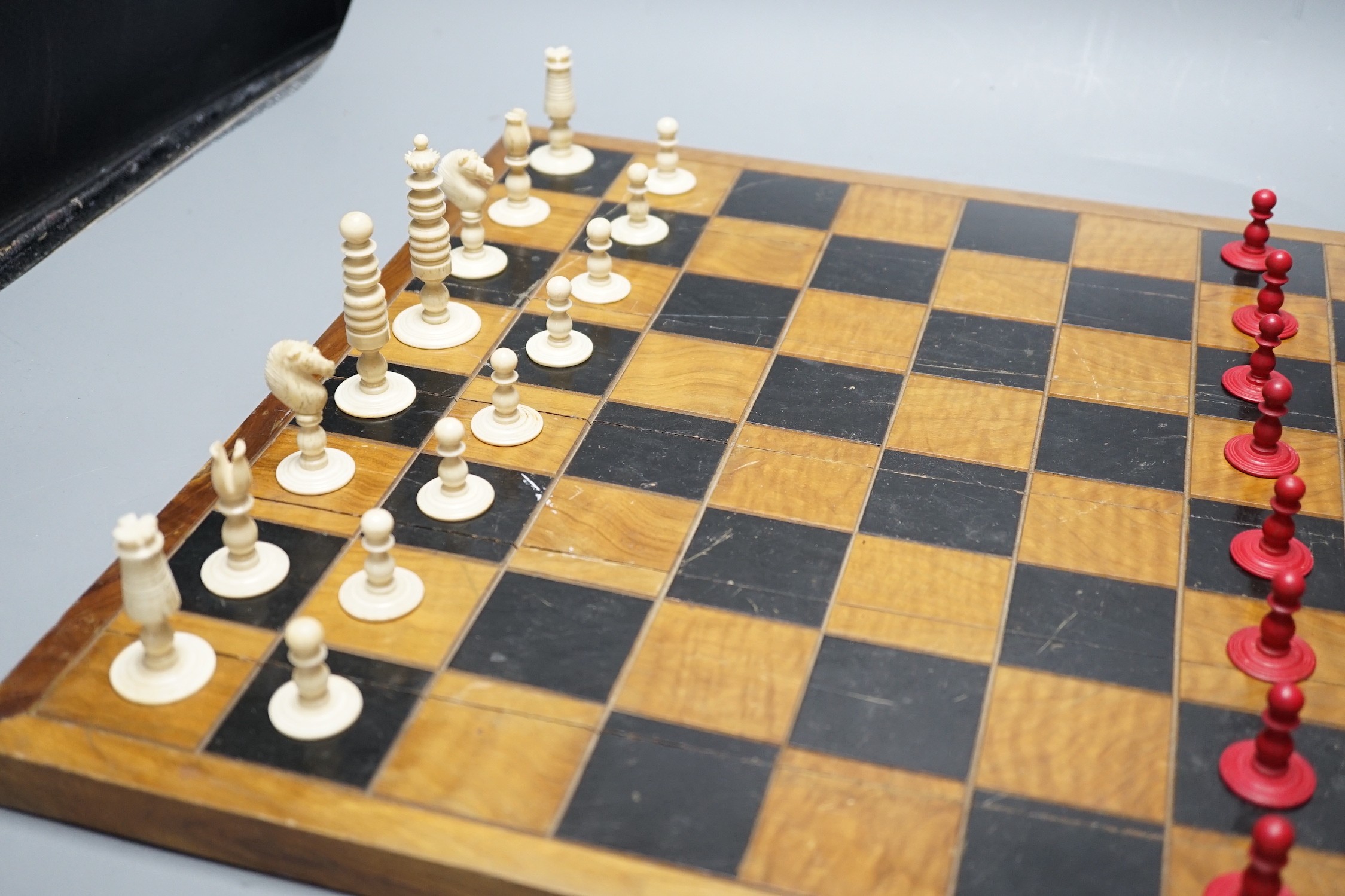 A 19th century bone chess set, Kings 7 cm with a later inlaid chessboard chess board